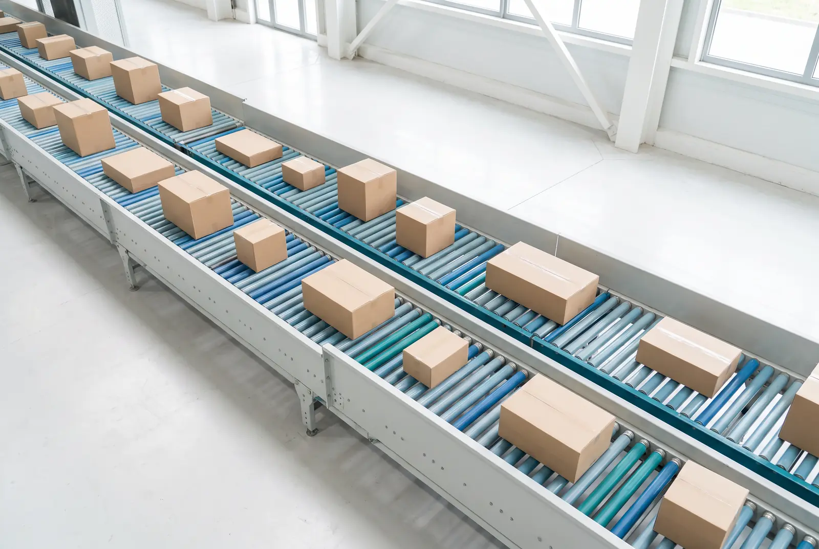 Boxes on a roller conveyor seen from above (illustration)